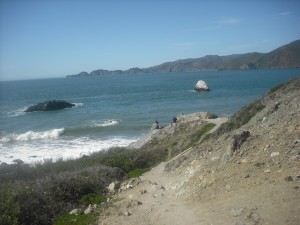 Hikers hang out on a rock near Marshall Beach, enjoying the unseasonably warm March weather.