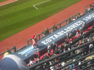 Strange peanut mascot dances on the dugout, much as Nero fiddled while Rome burned.