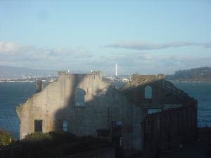 Derelict building on Alcatraz, with the San Francisco Bay Bridge in the background.